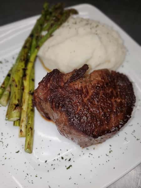Steak with a side of asparagus and mashed potatoes