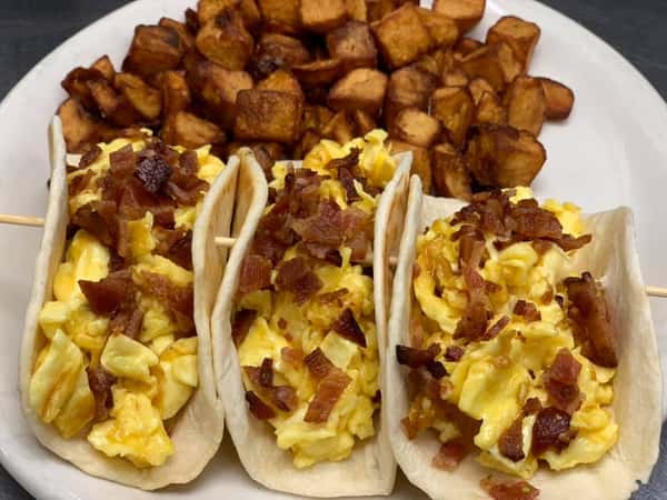 Breakfast egg and bacon tacos with a side of home fries