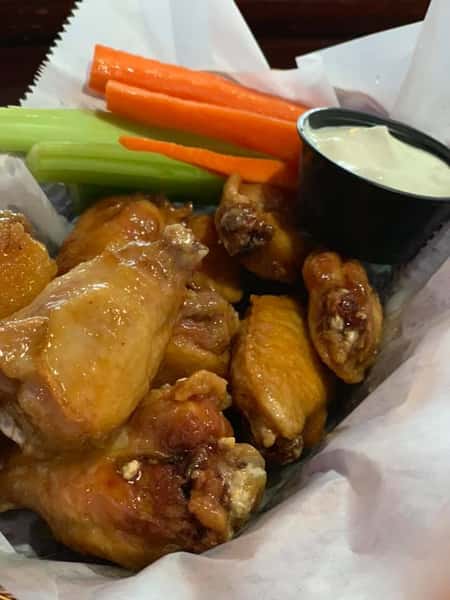 Chicken wings with a side of blue cheese and carrots and celery