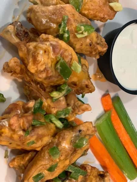 Buffalo wings with a side of carrots and celery and blue cheese