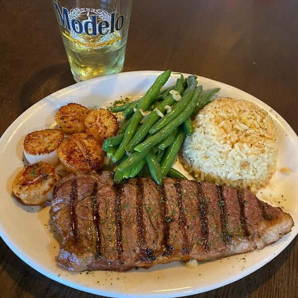 Steak with a side of green beans and rice