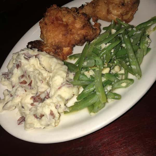 Fried chicken with a side of mashed potatoes and green beans