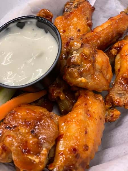 Buffalo chicken wings with a side of blue cheese, carrots, and celery
