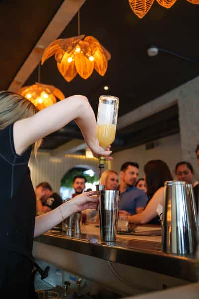 Bartender pouring drinks during a large event at the restaurant.