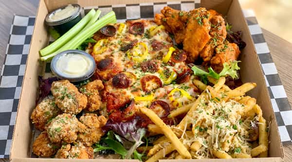 Pizza with pepperoni and yellow peppers, fried chicken wings, french fries with cheese, celery, and dipping sauces.