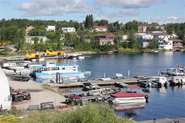 View of Howey Bay showing docked boats, water planes, and distant homes