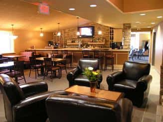 Bar and Lounge room with tables, leather chairs, banquet chairs.