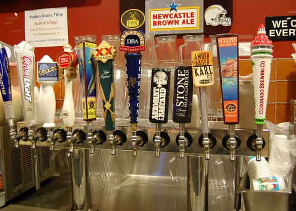 a variety of beer taps on draught at La Bella Pizza