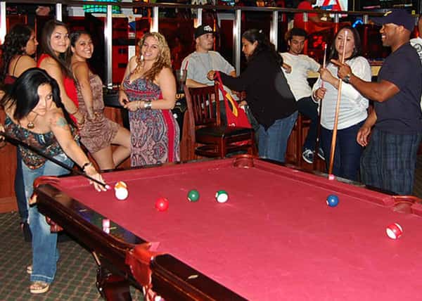 people playing biliards at the pool table