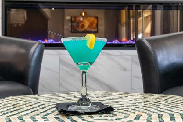 cocktail in front of a fire place