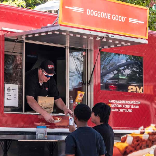 Customers getting food from the National Coney Island Food Truck
