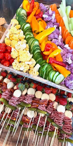 tray of veggies and meat and cheese skewers