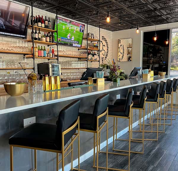 bar area with black and gold bar chairs