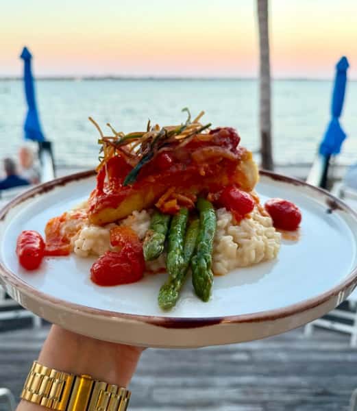 White wine, fennel, blistered tomato sauce, parmesan risotto, asparagus, crispy leeks