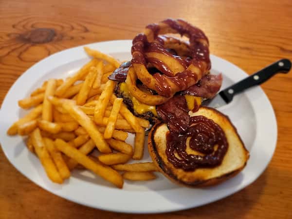 Half Pound American Wagyu Burger on Brioche Bun with Cheddar Cheese, Bacon, Barbeque Sauce, and Jumbo Onion Rings. Served with choice of side.