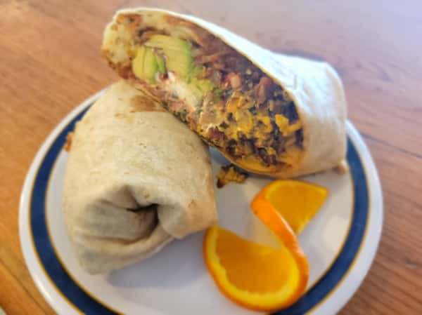 Bacon, Chorizo, Scrambled Eggs, Hash Browns, Sour Cream, Salsa, and Avocado grilled in a giant tortilla shell.