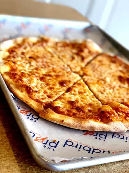 Classic cheese pizza with melted mozzarella and crispy thin crust served on a metal tray at a casual pizzeria