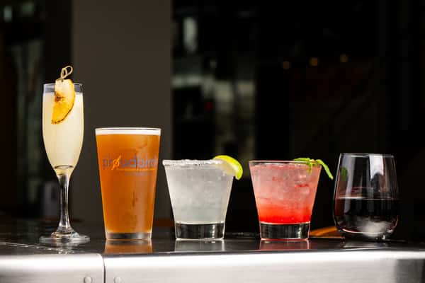 Cocktails, Beers, and Wines lined up in a row.