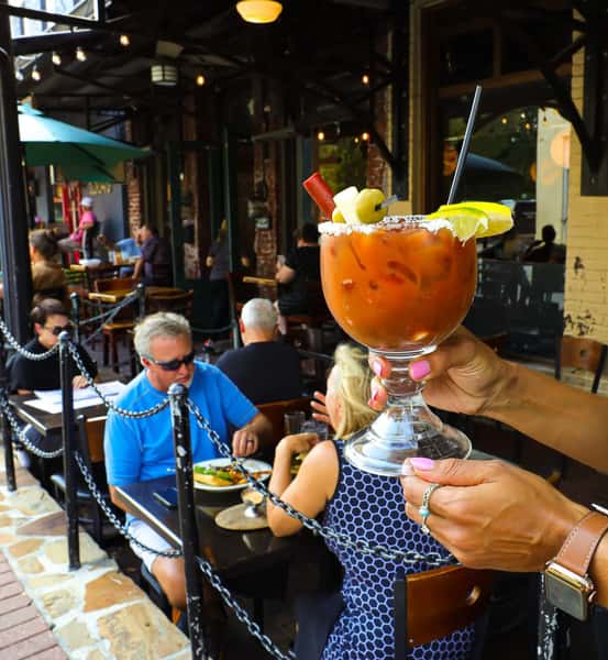 Person holding drink near customers