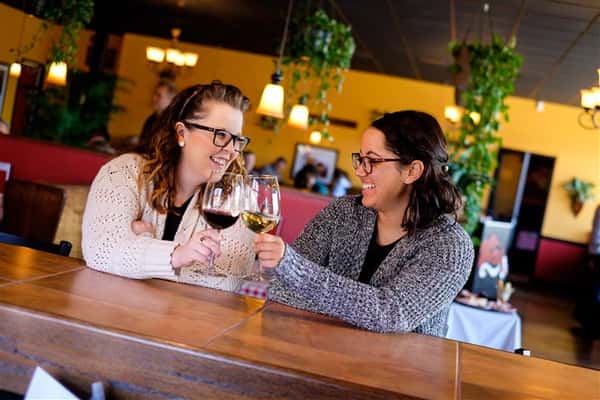 Two women having wine at the bar