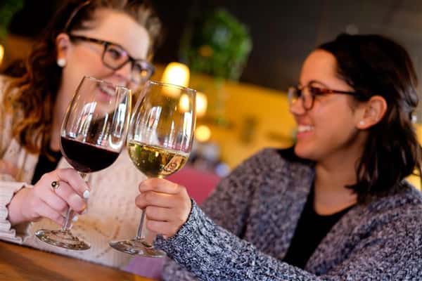 Two women having wine at the bar