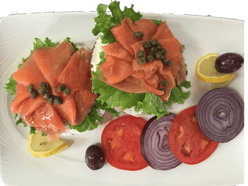 lox, cream cheese, and lettuce toast with an olive, tomato, and a red onion on the side