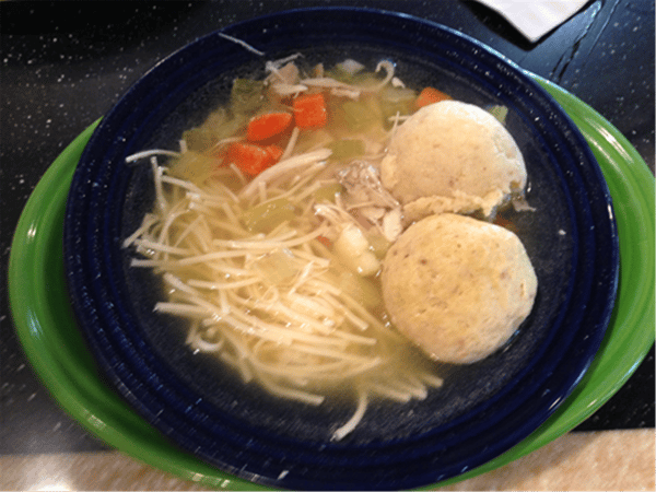 matzo ball soup with chicken, carrots, and celery