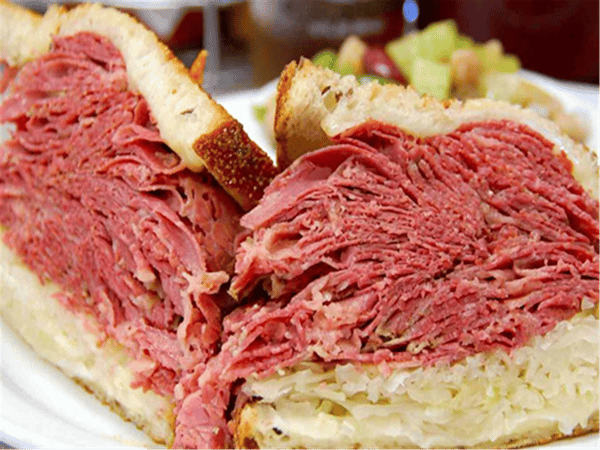 ruben sandwich on rye bread with sauerkraut on the bottom