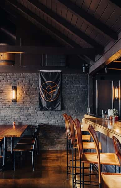 Whiskey 'N Rye interior with branded flag and wooden chairs