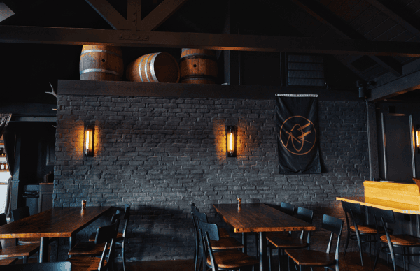 Whiskey 'N Rye interior with dark grey bricked wall and warm lighting
