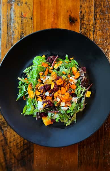 Mixed salad bowl on a wooden table