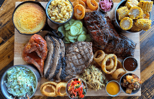 Variety of meat and side options for an outdoor spread