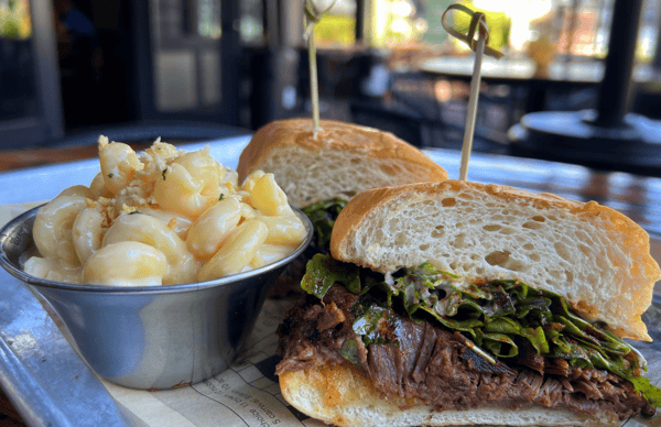 Meat sandwiches with a side bowl of pasta