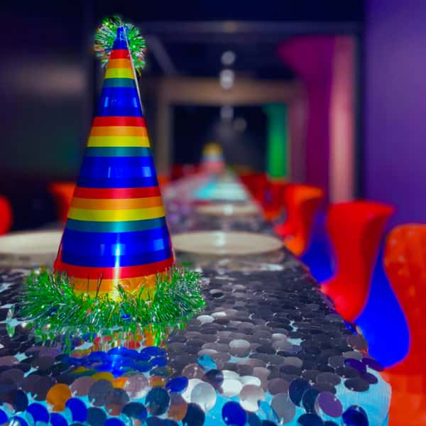 Birthday party hat on table set for the party