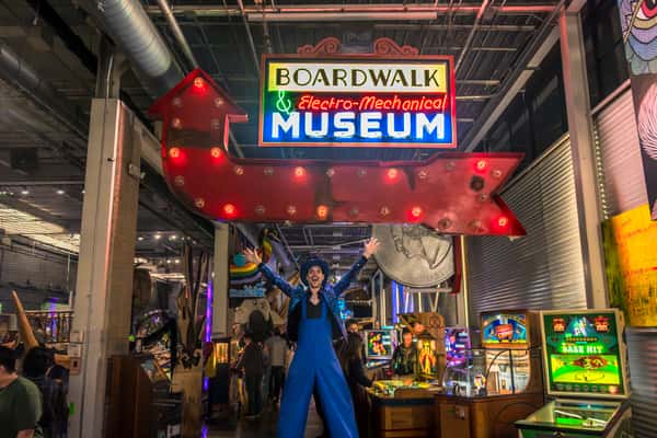 Boardwalk sign and stilt-walker at Can Can Wonderland