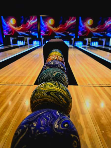 bowling balls in a row on the rack machine