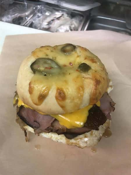 brisket sandwich with cheese and a cheesy jalapeno bun