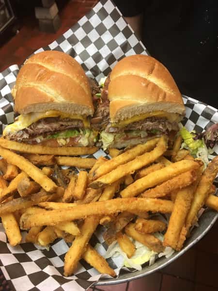 brisket sandwich with cheese, lettuce and tomatoes with fries on the side