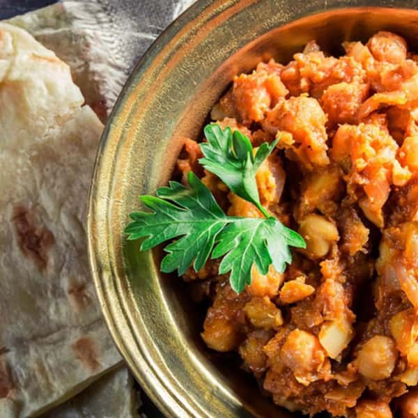Half-shot of indian curry in a dish with roti