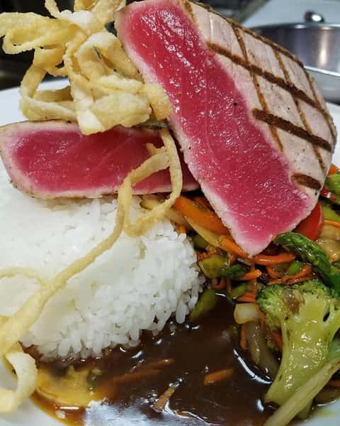 Seared ahi tuna with sticky rice, stir fried vegetables in soy chili ginger sauce.