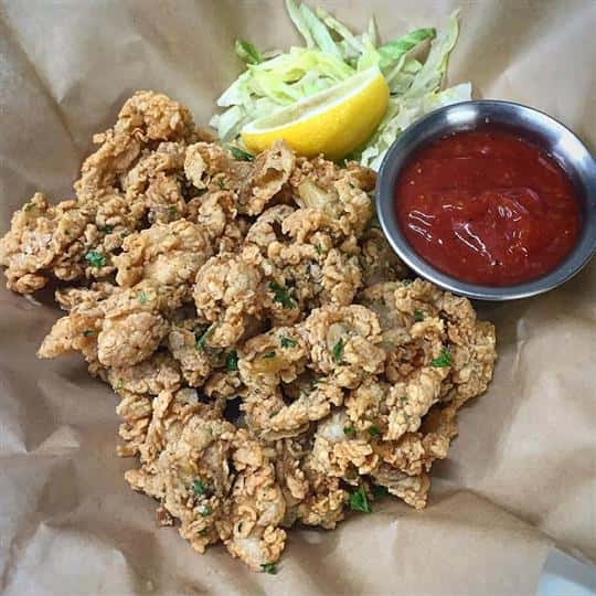 Fried belly clams with lemon and dipping sauce.