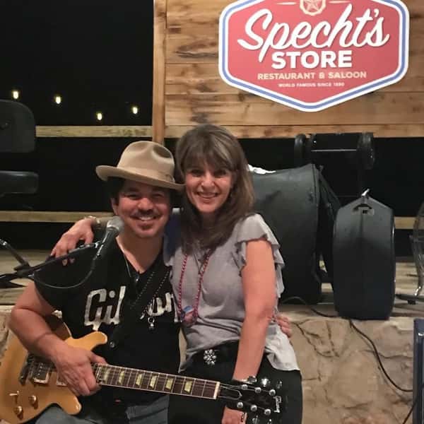 Two people hugging in front of Specht's stage