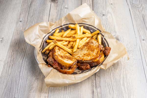 Texas brisket grilled cheese sandwich with crispy French fries at Spechts Texas Bar & Grill.
