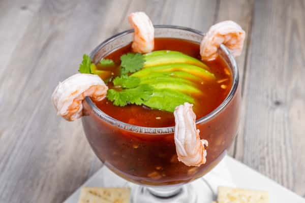 Shrimp cocktail with avocado, cilantro, lime, and crackers served at Spechts Texas Bar & Grill.