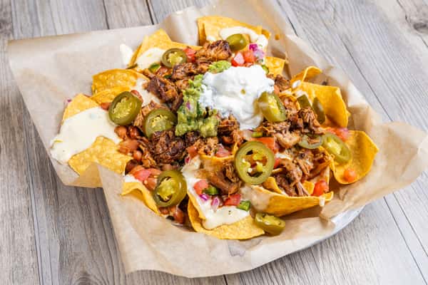 Supreme nachos in paper and basket