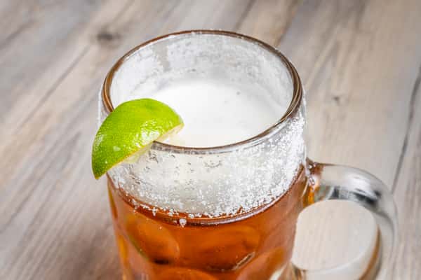 Frosted beer stein with a salted rim and fresh lime at Spechts Texas Bar & Grill, an authentic Texas saloon.