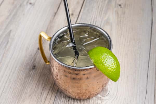 Texas Mule cocktail served in a hammered copper mug with a fresh lime garnish at Spechts Texas Bar & Grill.