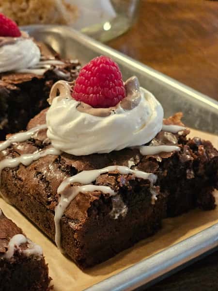 Brownie w/ chocolate & Vanilla Whipped Cream. Topped w/ a Raspberry