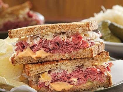 reuben sandwich topped with sauerkraut, and Russian dressing