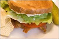Chicken sandwich with lettuce, tomato, and mayo